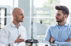 Two men discussing product in company