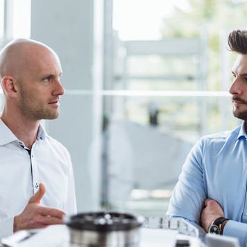 Two men discussing product in company