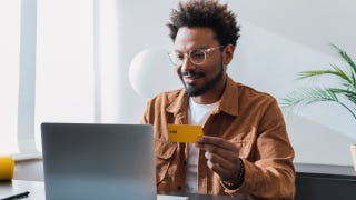 Smiling businessman making payment with credit card