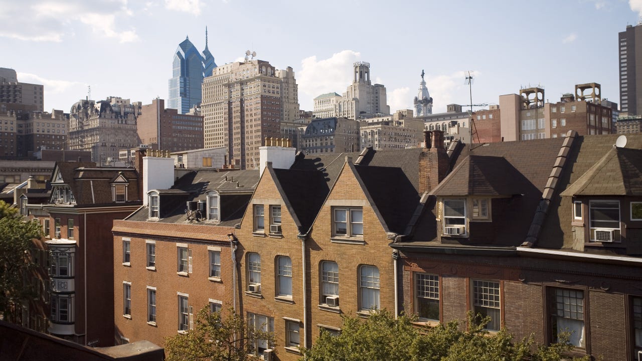 Rooftop view of Center City Philadelphia with William Penn on top of City Hall in the background. On Spruce Street near Washington Square. Old and new architecture.