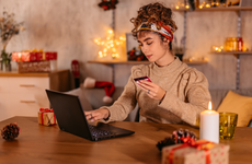 Beautiful young woman shopping online at home during Christmas holidays,