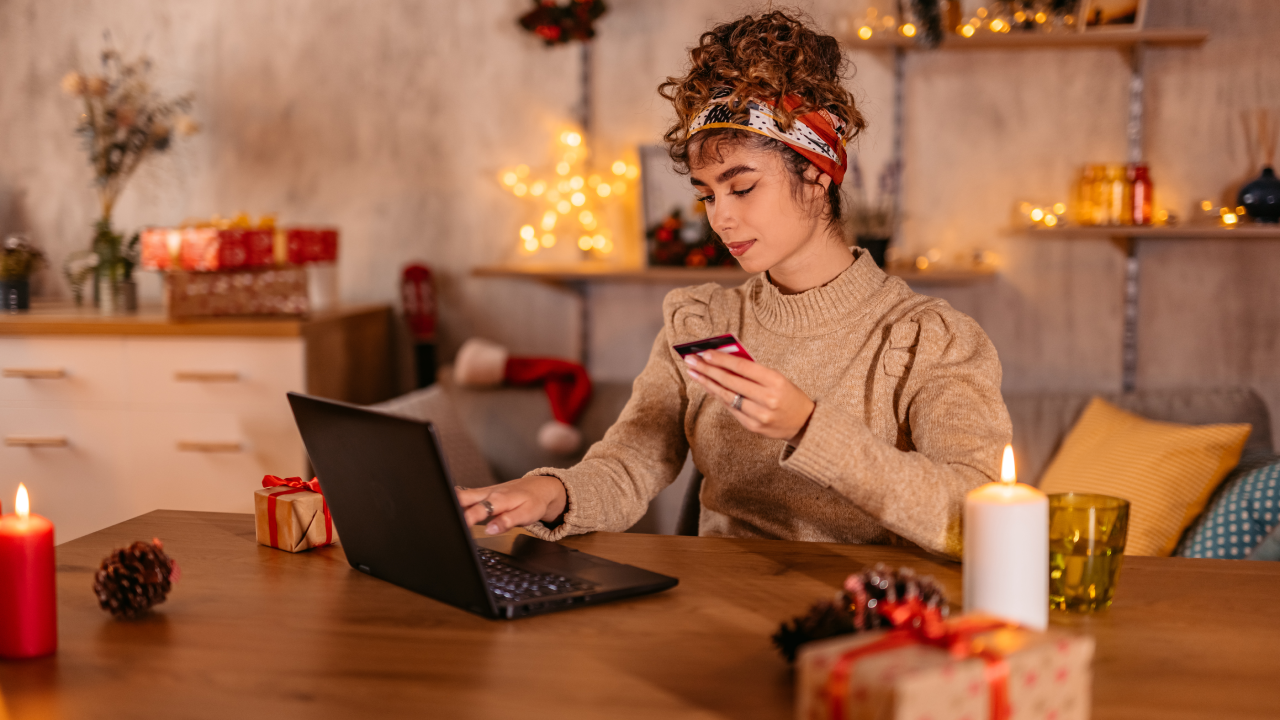 Beautiful young woman shopping online at home during Christmas holidays,