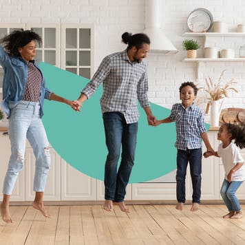 A happy family jumping in a kitchen