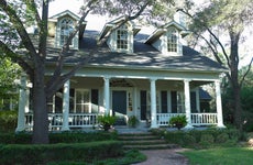 white house in san antonio texas with wide, columned front porch