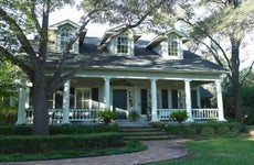 white house in san antonio texas with wide, columned front porch