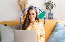 Woman accessing her checking account at home on a laptop
