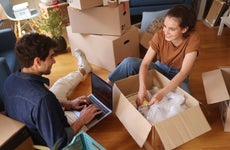 couple unpacking boxes together