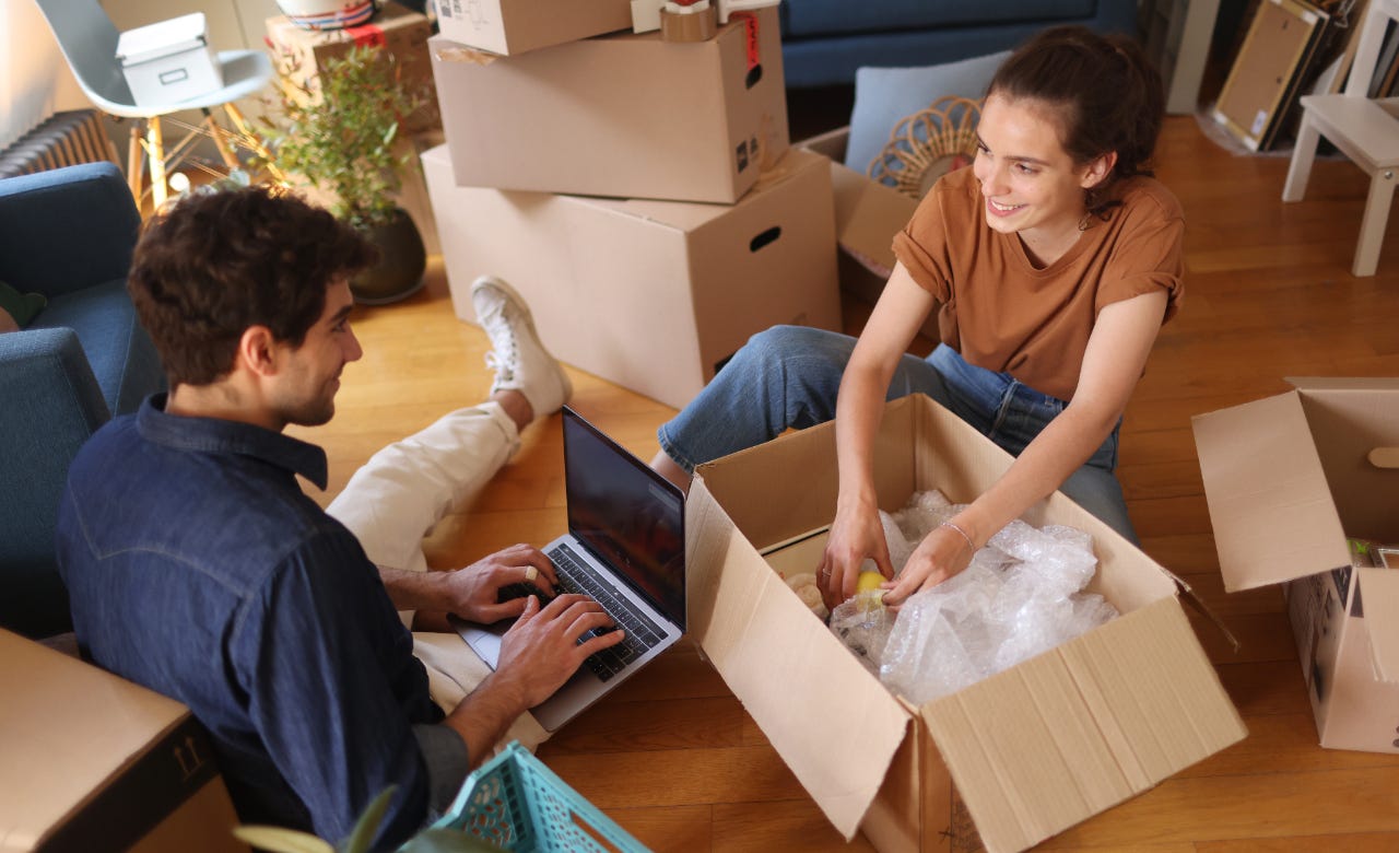 couple unpacking boxes together