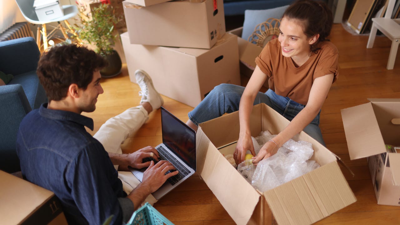 couple unpacking boxes together