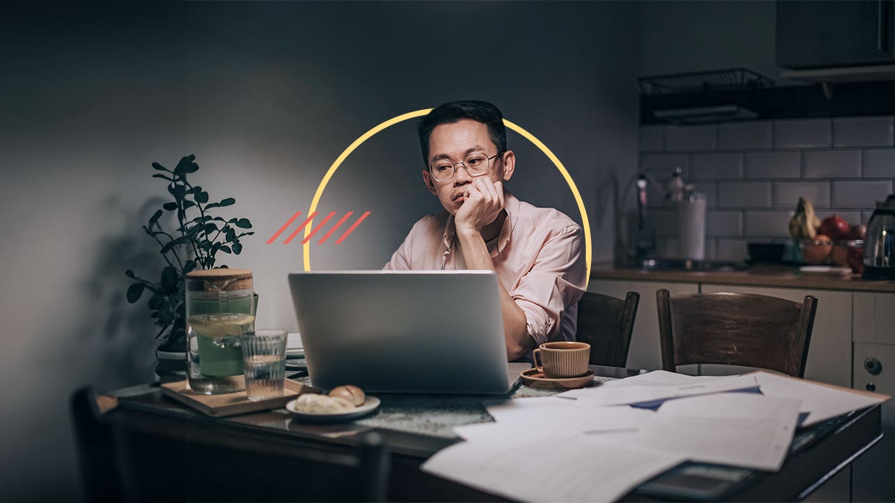 Man lost in thought as he sits at his office desk