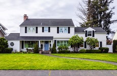 large white colonial style house exterior, green grass