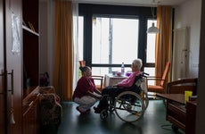 Inside of a nursing home, nurse and resident