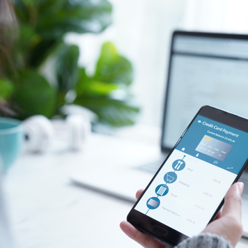 Woman checking credit card outstanding balance on mobile banking account