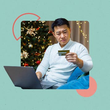 Man typing a credit card number into a laptop