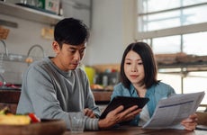 couple planning 401(k) finance options with digital tablet at home