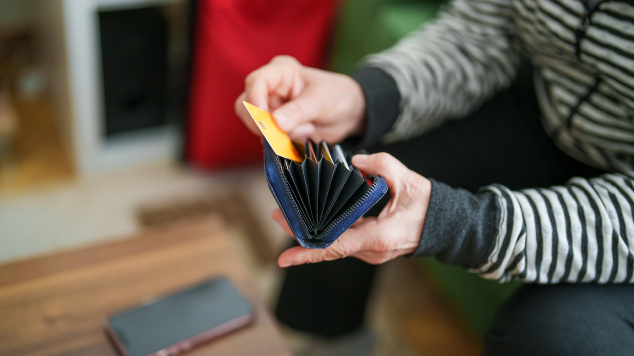 Senior woman making online shopping with her credit card on mobile phone