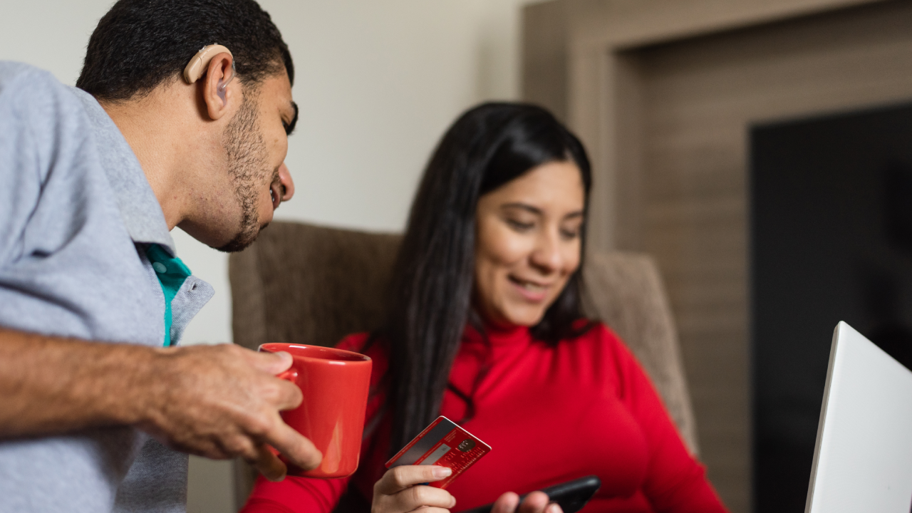 Deaf young people on online shopping using laptop at home