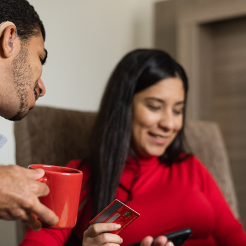 Deaf young people on online shopping using laptop at home