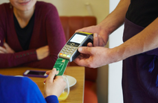 Cropped shot of woman inserting card into credit card machine in restaurant