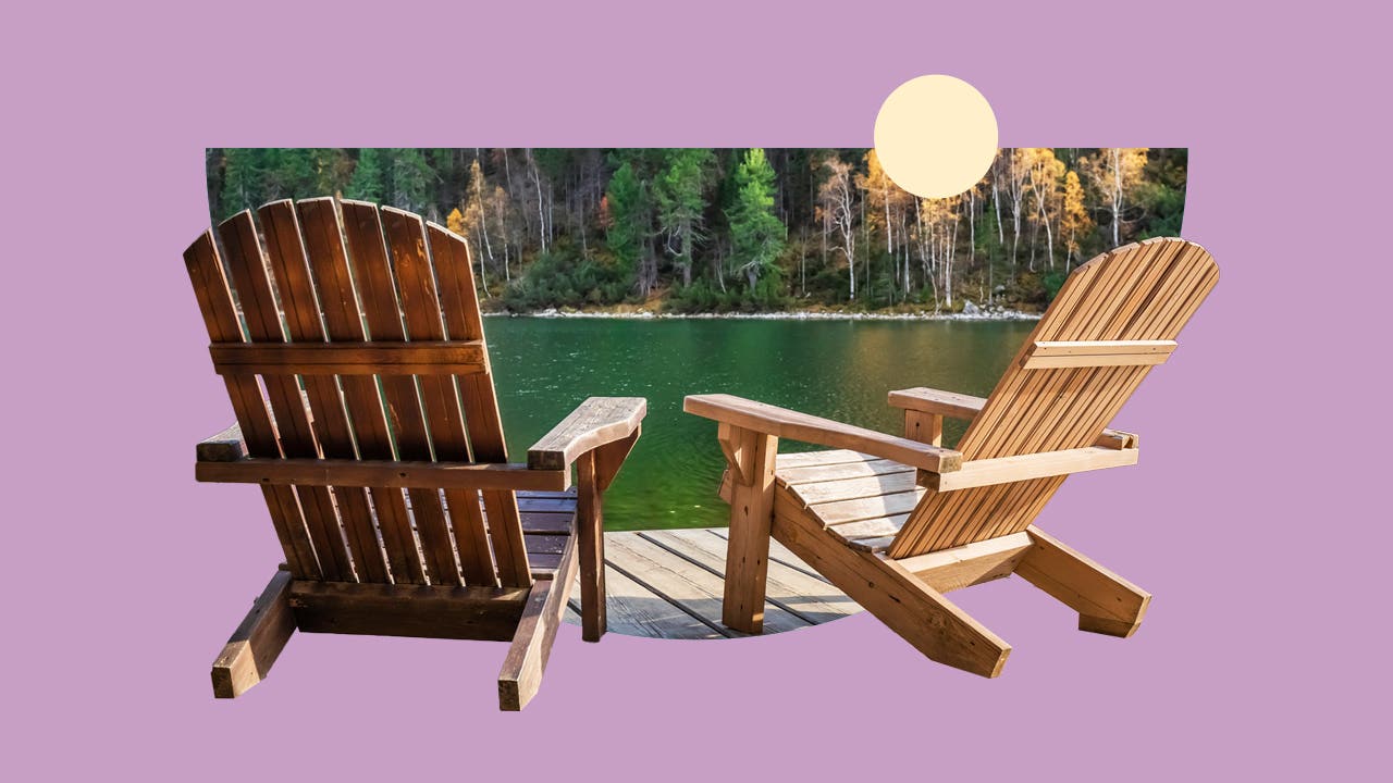 Scenic view of two wooden chairs on the edge of a lake in the forest