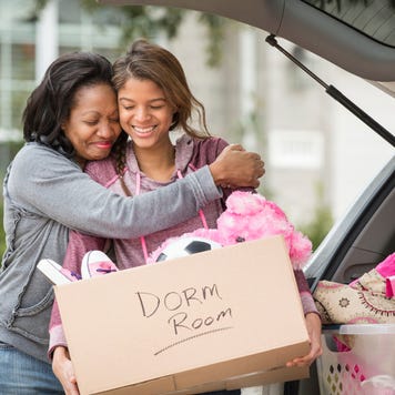 mother helping daughter pack for college