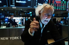 Stock trader Peter Tuchman works on the floor of the New York Stock Exchange