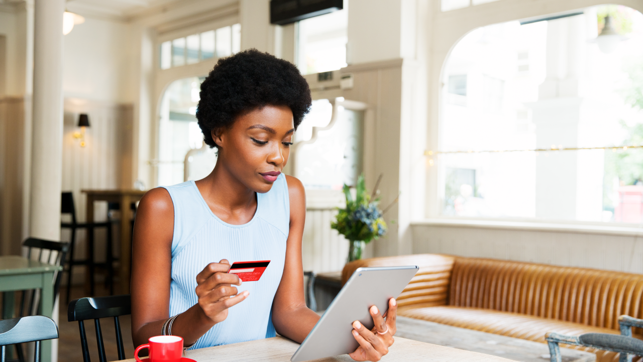 Woman with credit card and tablet