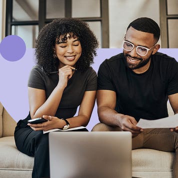 A couple reviewing their finances and sitting in front of a laptop