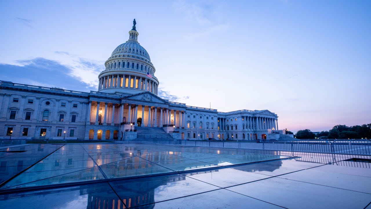 The US Capitol Building at dusk.