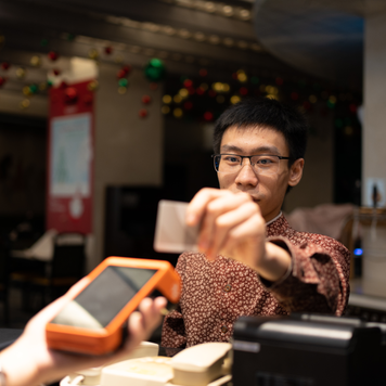 man paying with credit card