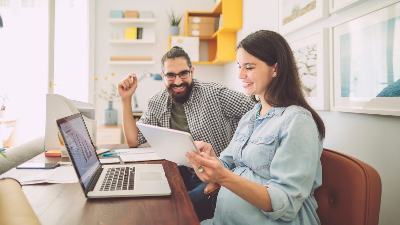 A couple discussing finances while sitting in front of a laptop