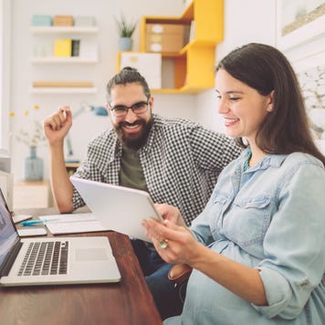 A couple discussing finances while sitting in front of a laptop
