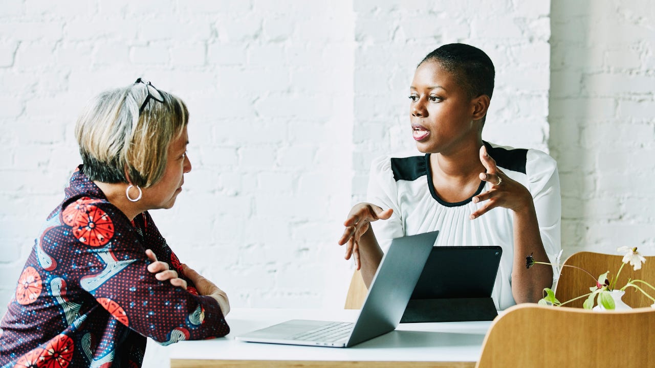 financial advisor in discussion with client in office conference room