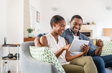 couple doing online shopping with credit card card at home