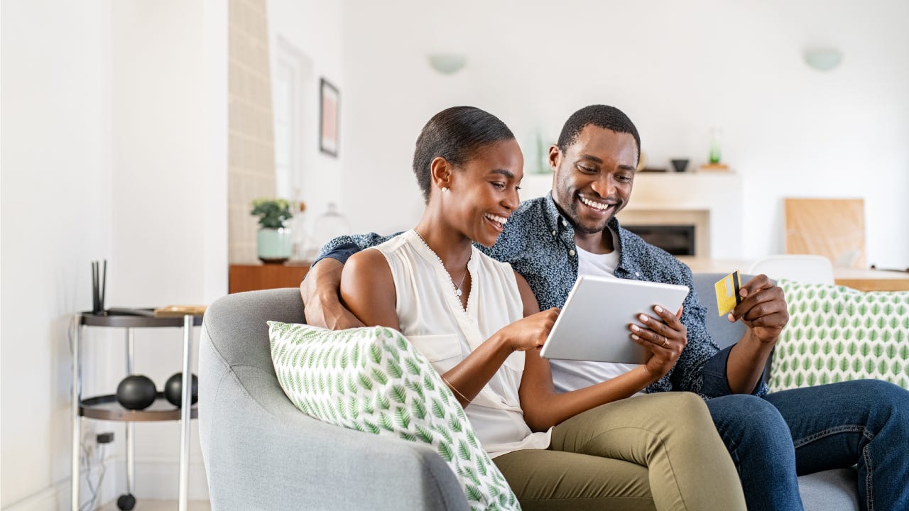 couple doing online shopping with credit card card at home