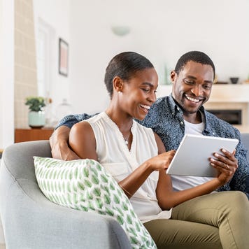 couple doing online shopping with credit card card at home