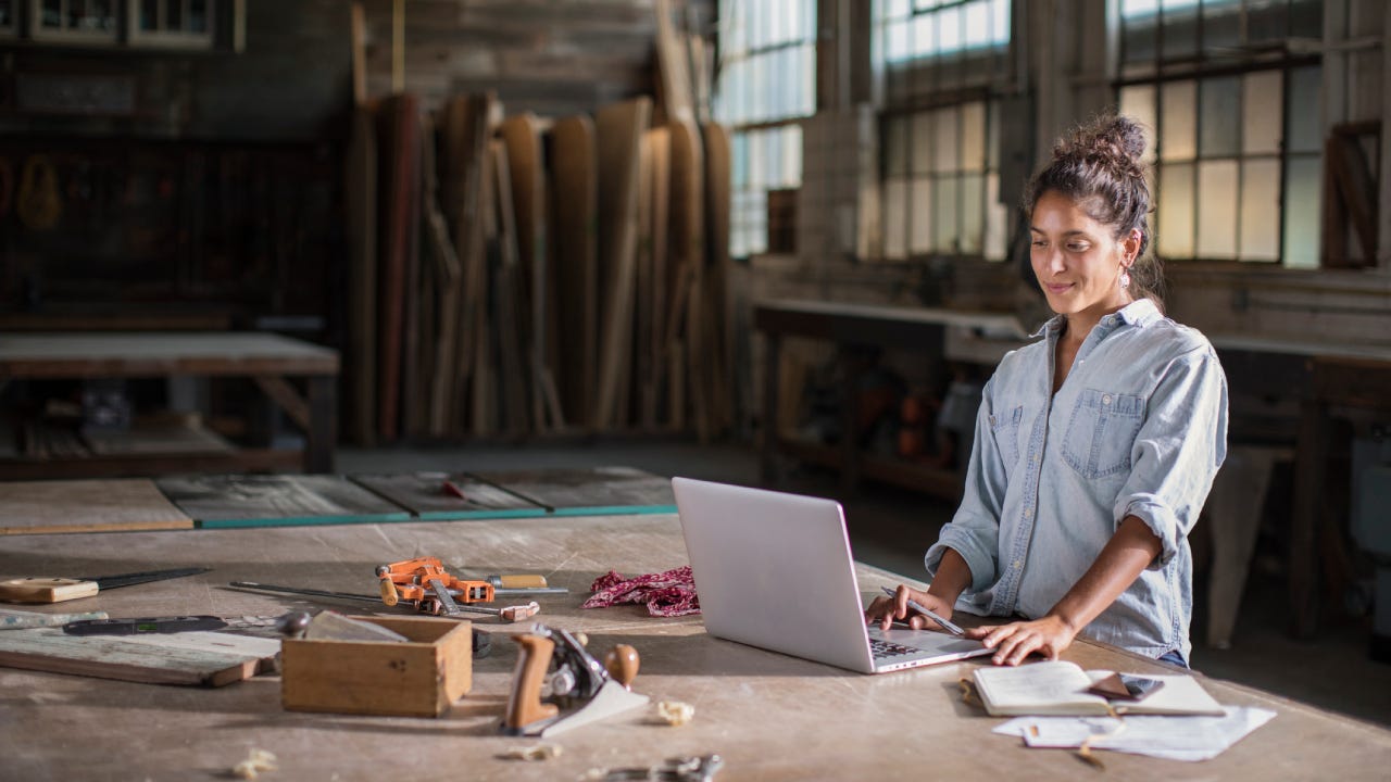 Female Entrepreneur Solving a Complicated Business Challenge with Pencil, Laptop, Carpentry Tools, and Confidence