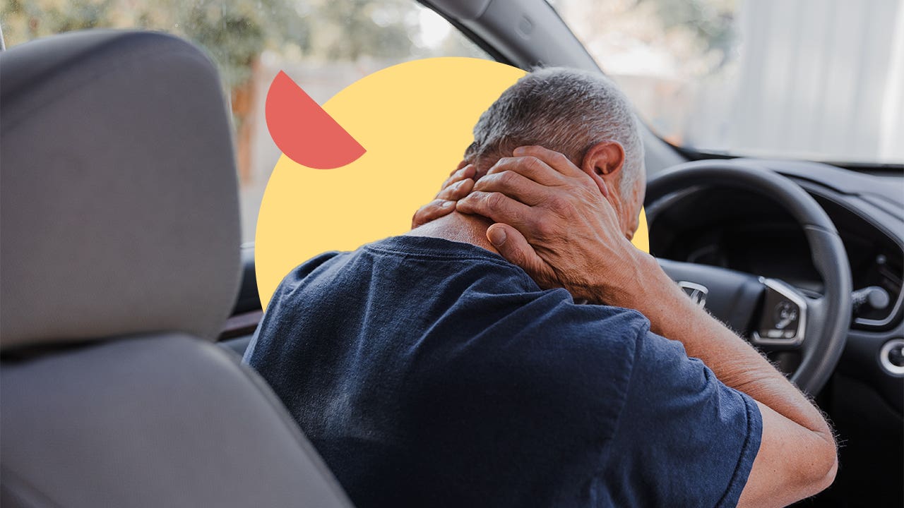 A driver massaging the back of their neck after a collision