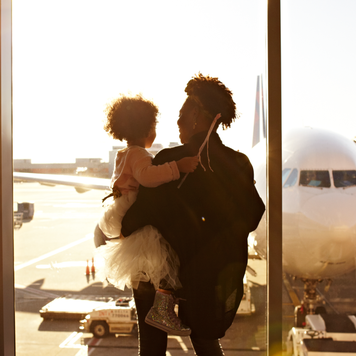 Mother holding daughter at airport