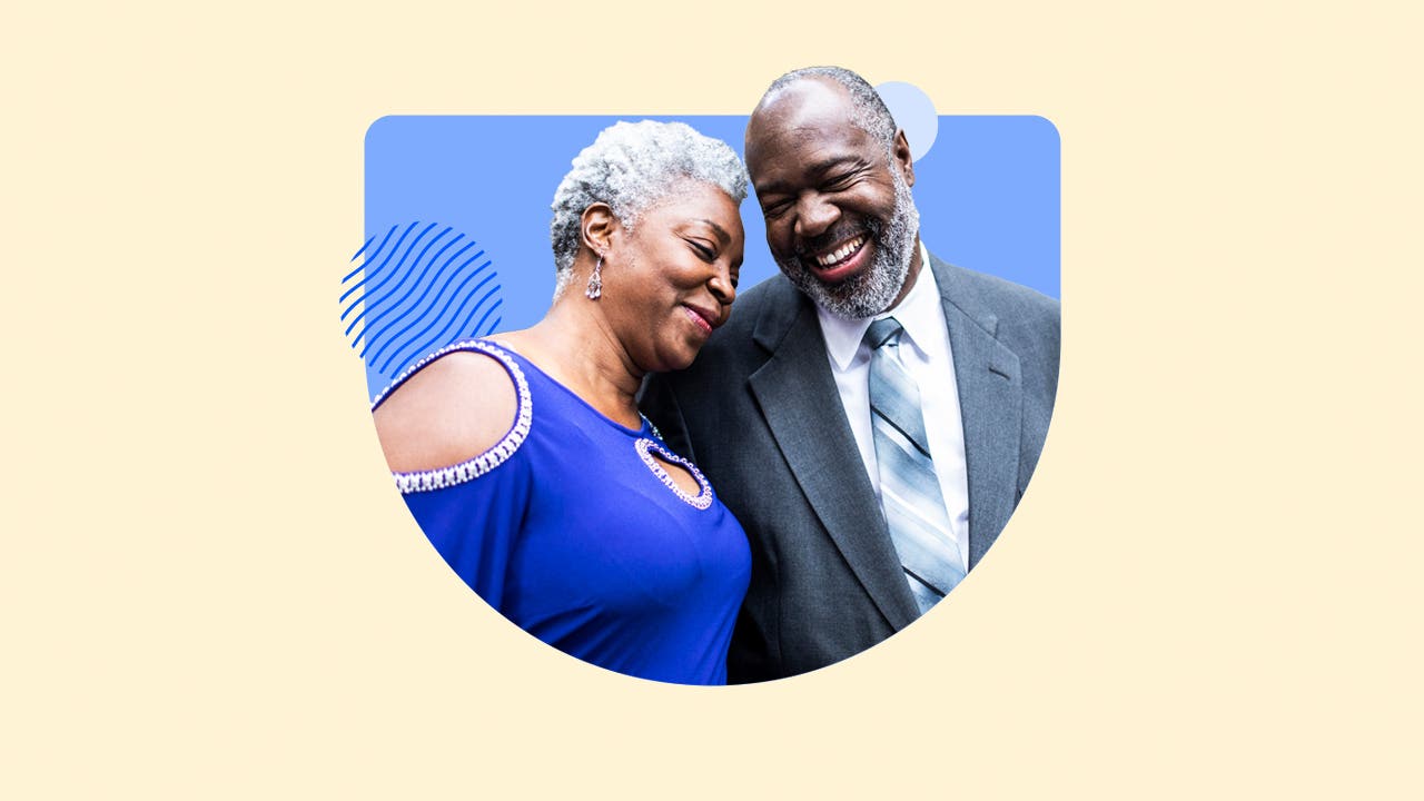 An elderly couple laughing and leaning into each other