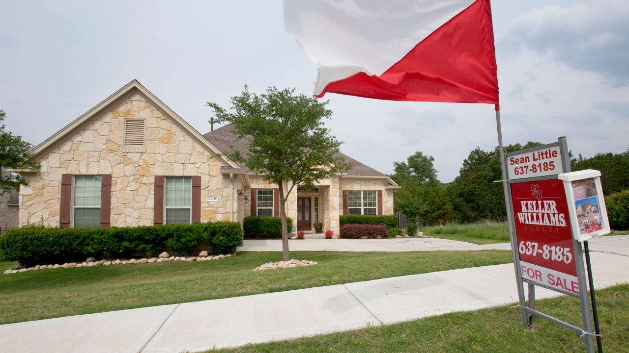 A flag flies outside a home for sale through Keller Williams