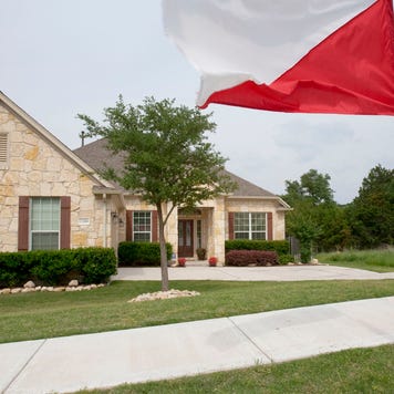 A flag flies outside a home for sale through Keller Williams