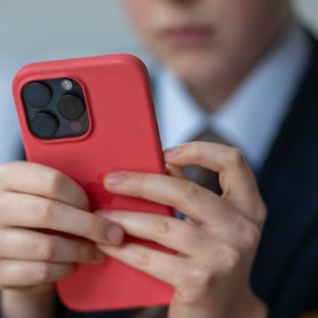12-year-old school boy looks at a iPhone screen