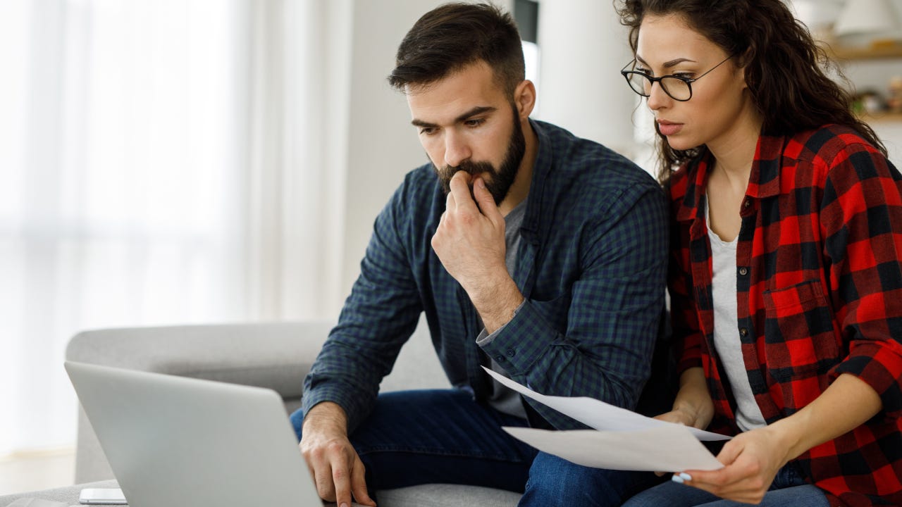 Young couple going through their paperwork together at home