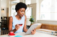 Woman with credit card and tablet