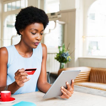 Woman with credit card and tablet