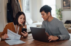 Young Asian couple going through home finances