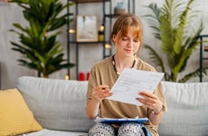 Young Woman Checking Her Finances At Home