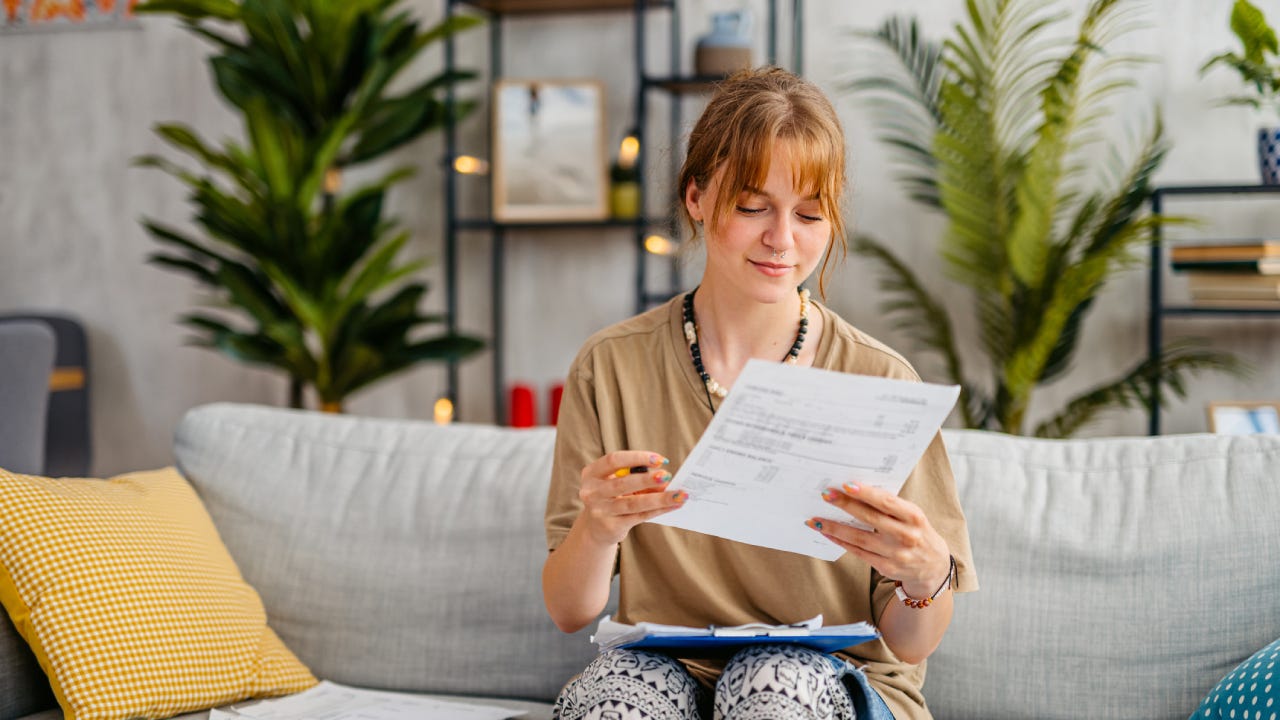 Young Woman Checking Her Finances At Home