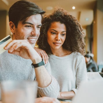 Couple in cafe shopping online